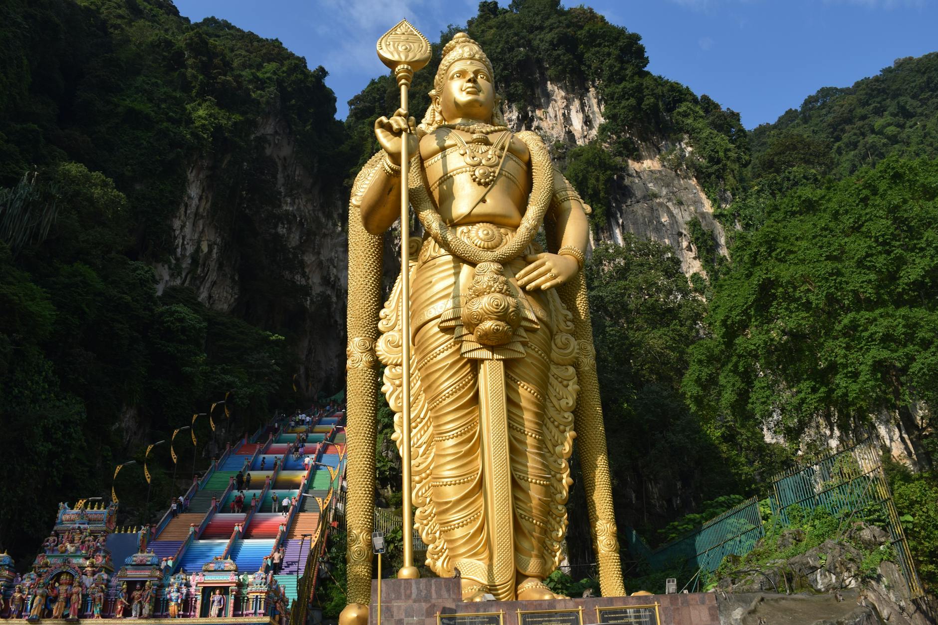 Colorful rainbow steps leading up to Batu Caves temple in Kuala Lumpur Malaysia with the golden Lord Murugan statue