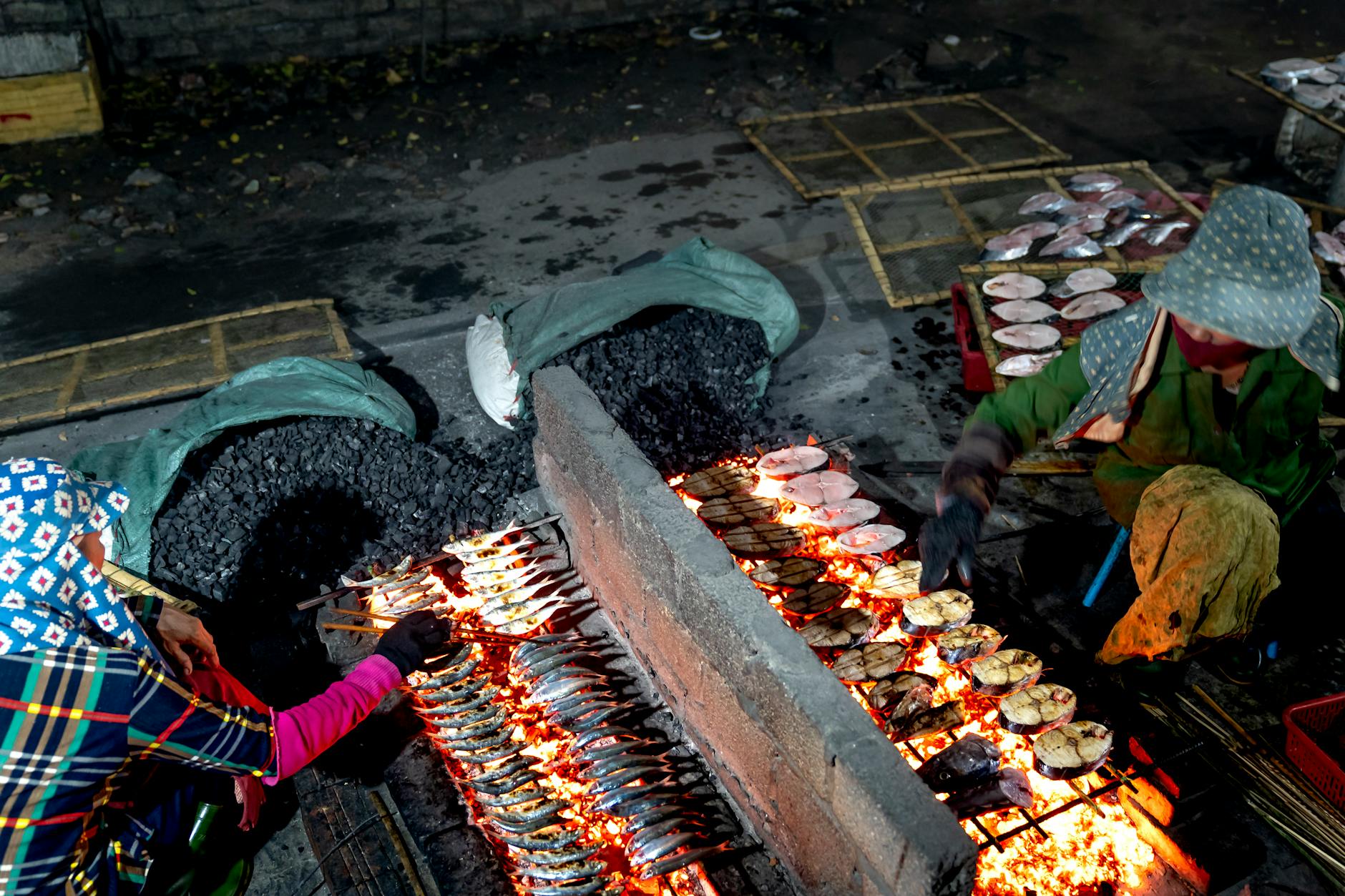 Fresh fish being grilled at an open-air street market stall in Kota Kinabalu Sabah