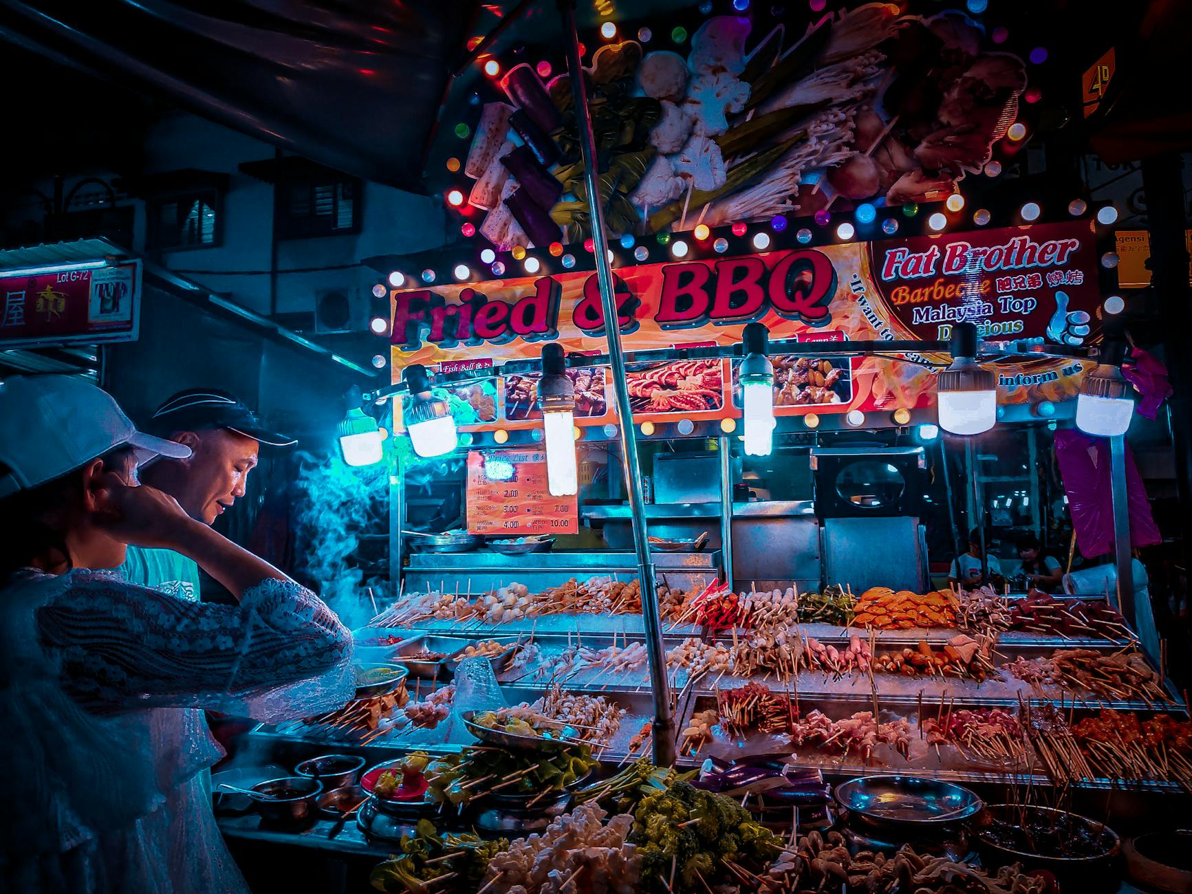 Street food hawker stall in Kuala Lumpur serving local Malaysian dishes
