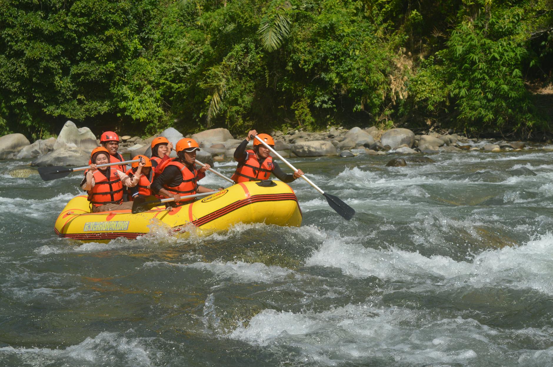 Rafters paddling through exciting white water rapids on a scenic river