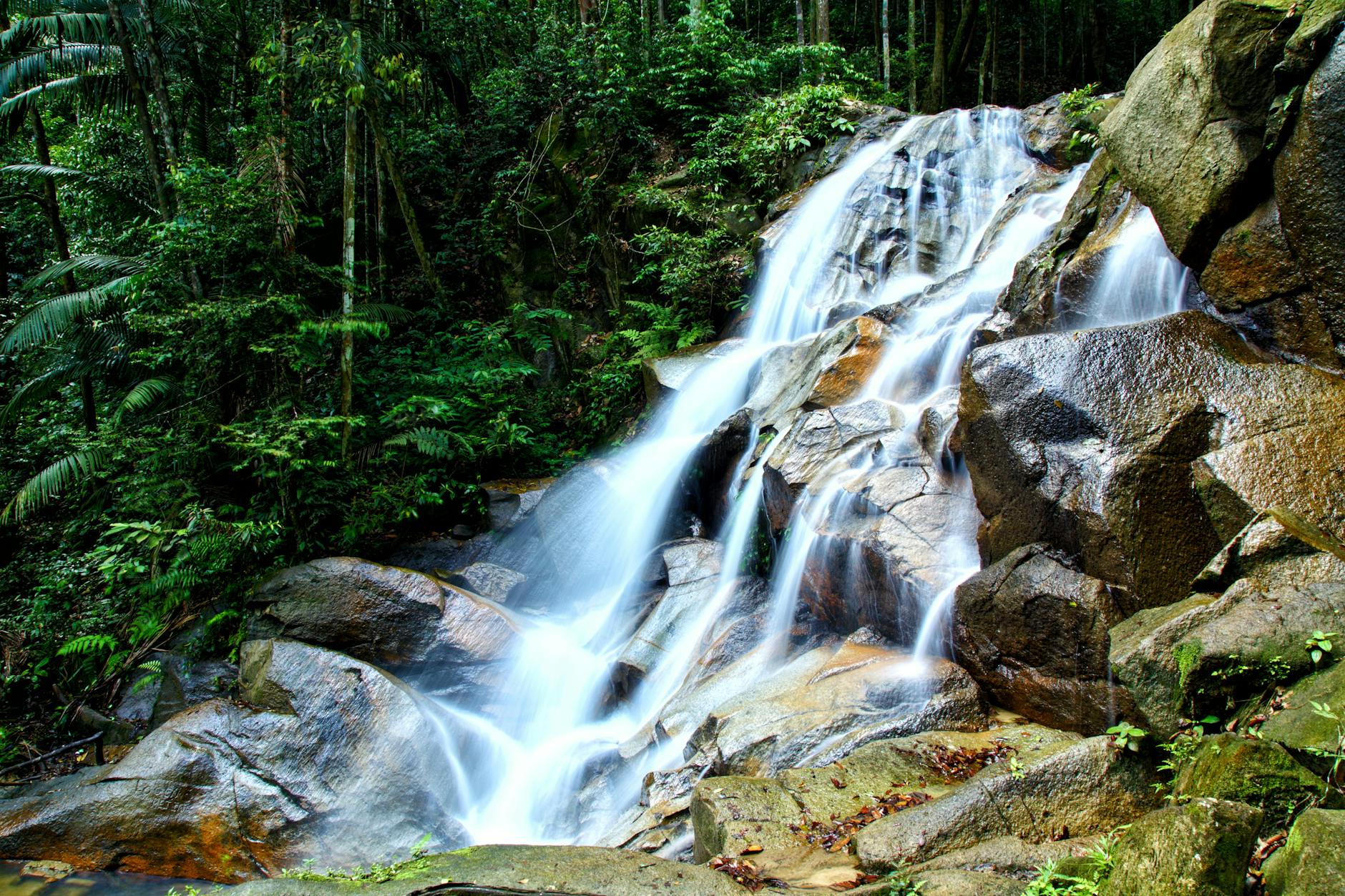 Tropical jungle waterfall surrounded by lush rainforest on Tioman Island Malaysia