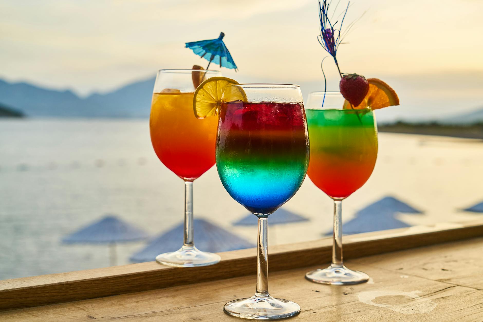 Colorful tropical cocktails with garnishes served at a sunset beach bar perfect for enjoying Malaysia nightlife on the islands