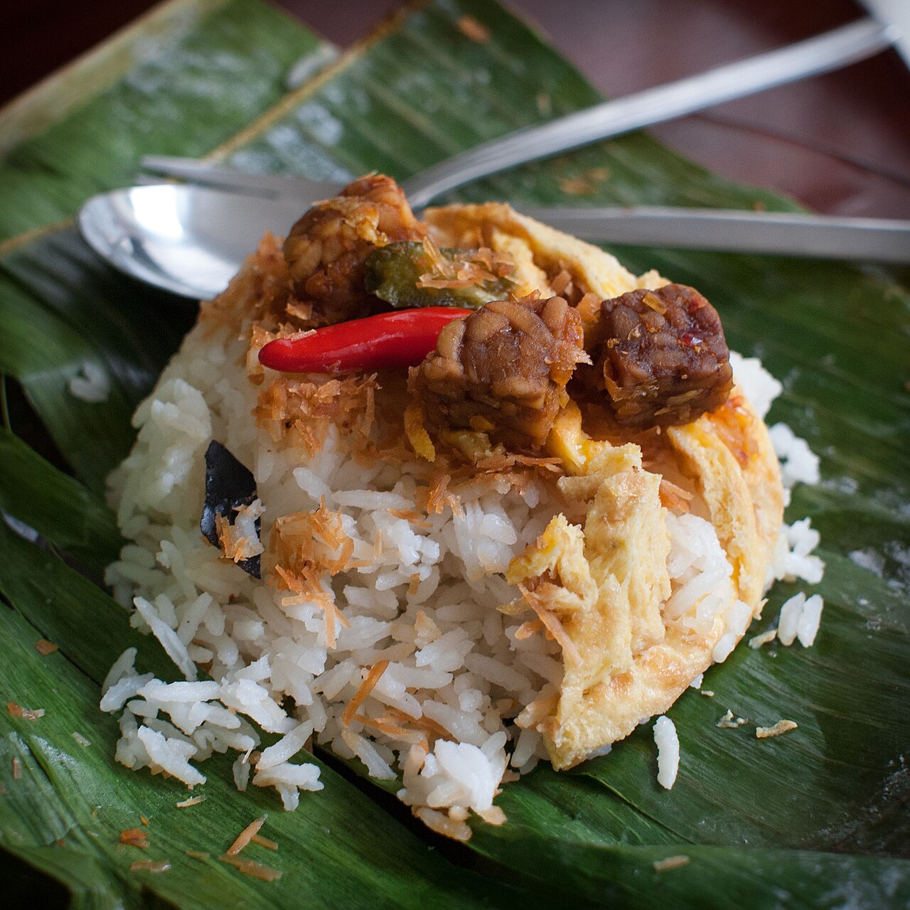 Nasi lemak wrapped in banana leaf at a Malaysian roadside stall