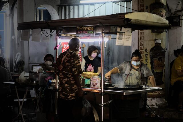 Hawker stall cooking char koay kak in George Town, Penang, Malaysia