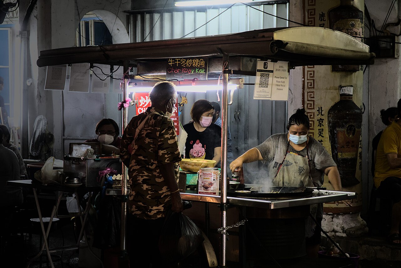 Hawker stall cooking char koay kak in George Town, Penang, Malaysia
