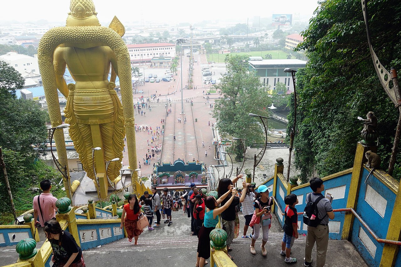 The view down from the Batu Caves staircase past the gold Murugan statue
