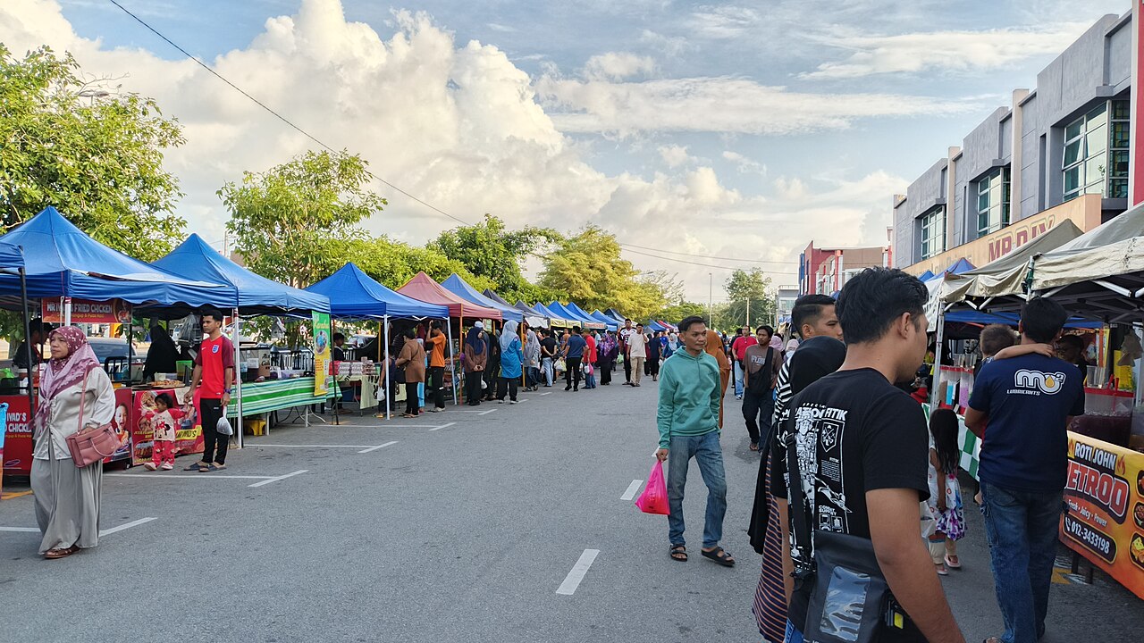 Stalls and shoppers at a Ramadan bazaar in the late afternoon