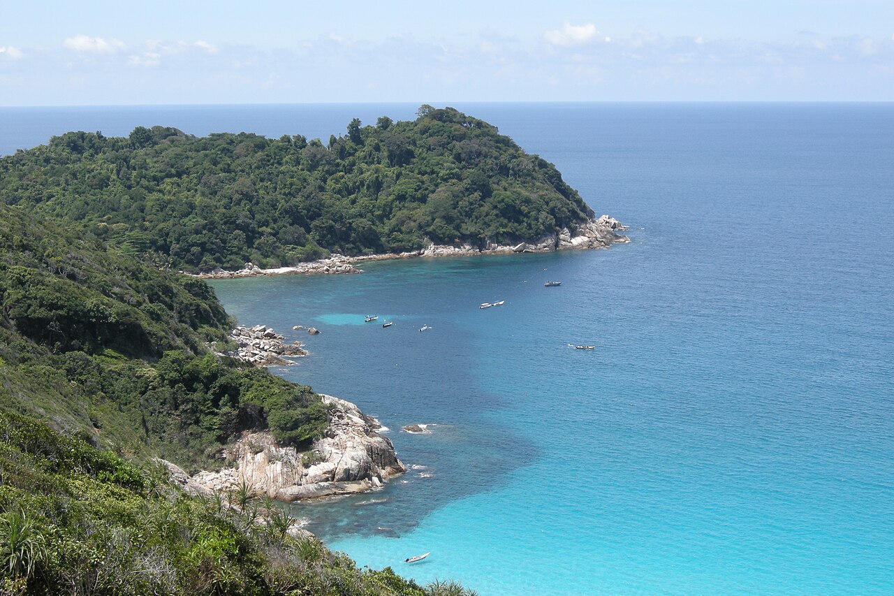 The forested coastline and turquoise water of the Perhentian Islands