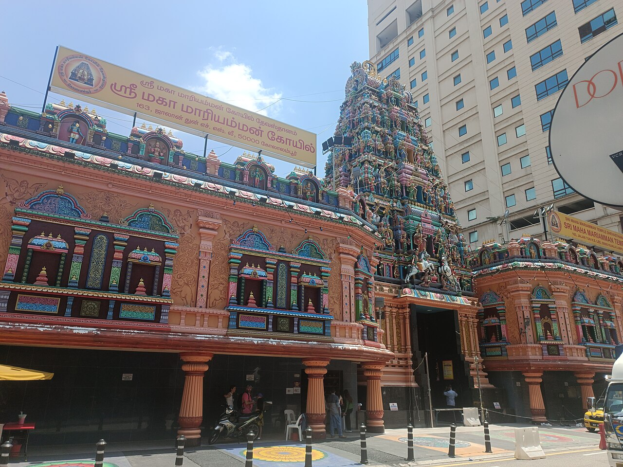 The carved gopuram of the Sri Mahamariamman Temple against a modern tower in Kuala Lumpur