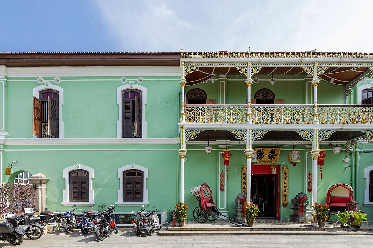 The green facade and cast-iron balustrades of the Pinang Peranakan Mansion on Church Street, George Town
