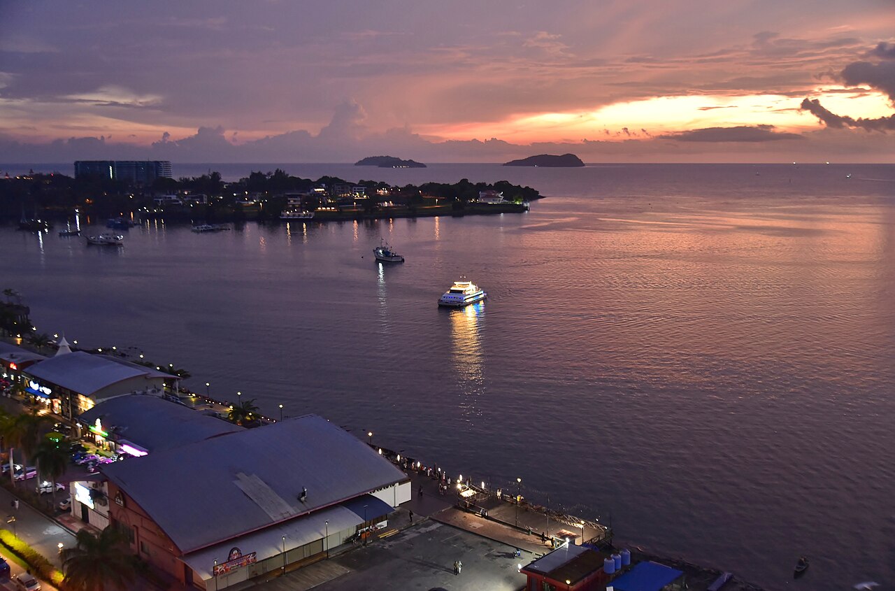 Kota Kinabalu waterfront skyline with hotels and the South China Sea at dusk