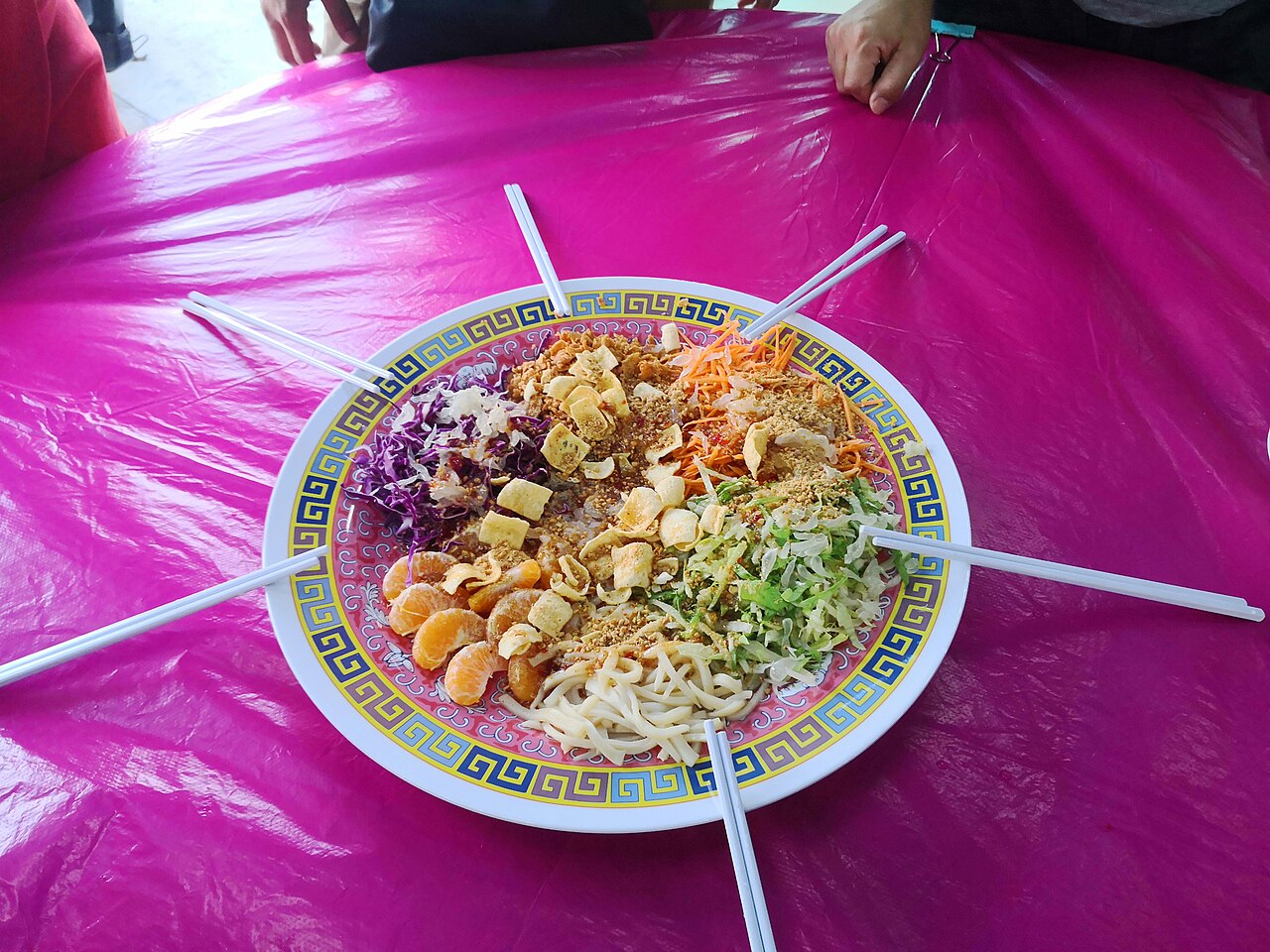 A platter of shredded vegetables and raw fish arranged for the yee sang prosperity toss