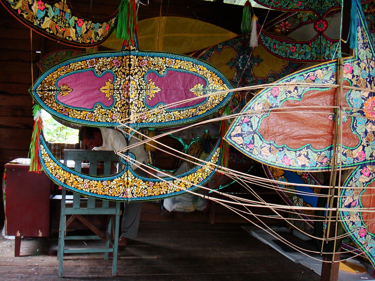 Decorated wau kites and their bamboo frames in a kite-maker's workshop in Kelantan