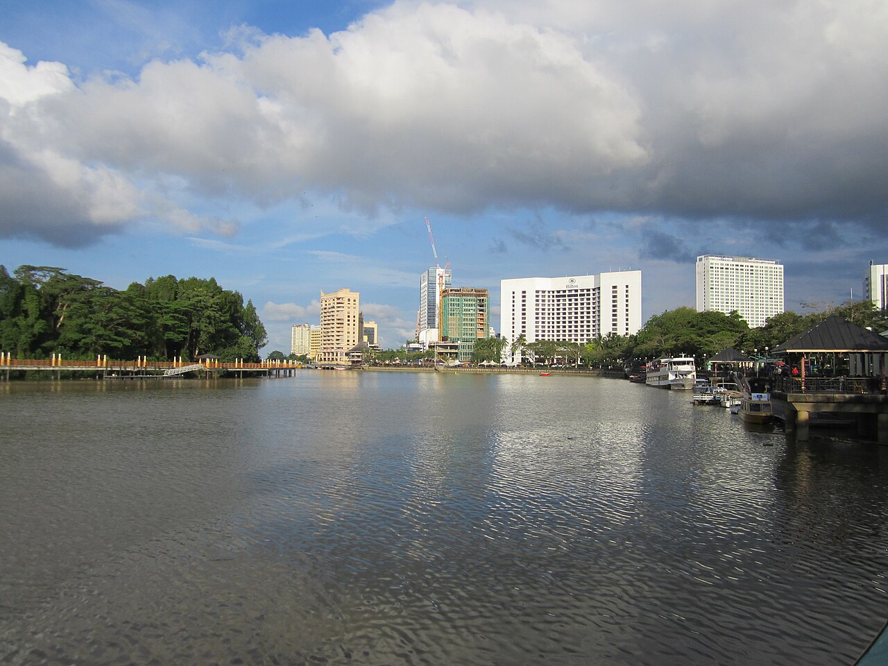 Kuching riverfront promenade along the Sarawak River with the old town skyline